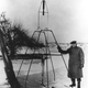 Robert Goddard poses with a liquid oxygen-gasoline rocket in its launching frame on March 16, 1926, at Auburn, Massachusetts (NASA)